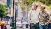 A male couple walking outside in an urban setting.